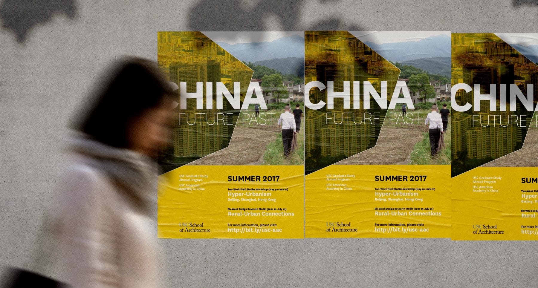 woman walking past a poster for the USC China program