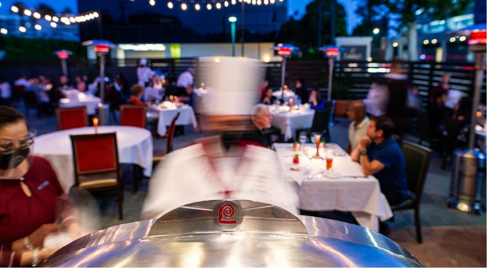 diners on an outdoor patio at dusk