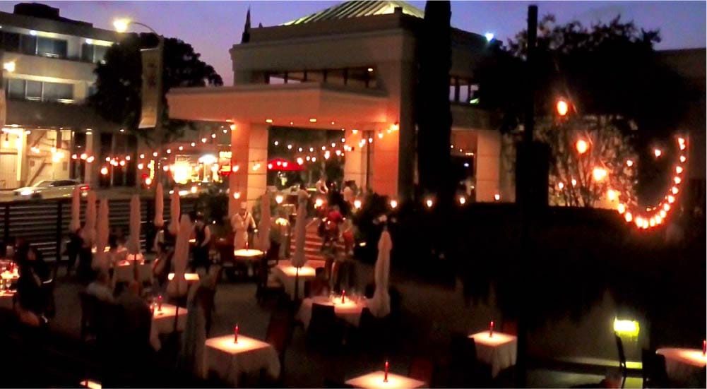 outdoor diners under twinkle lights